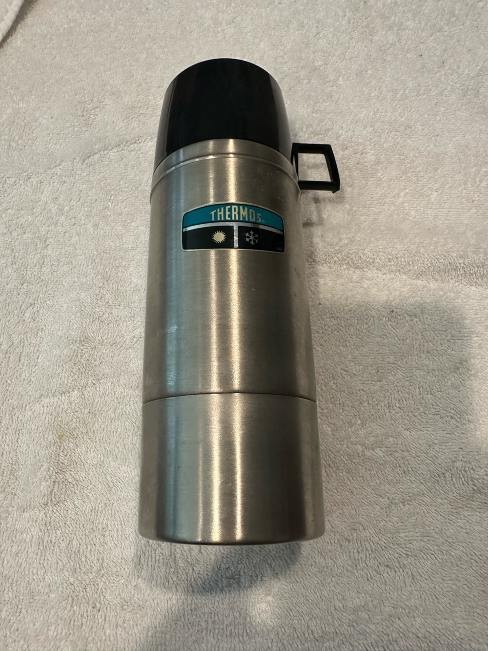 Thermos Stainless Steel Bottle with Black Lid and Teal Logo